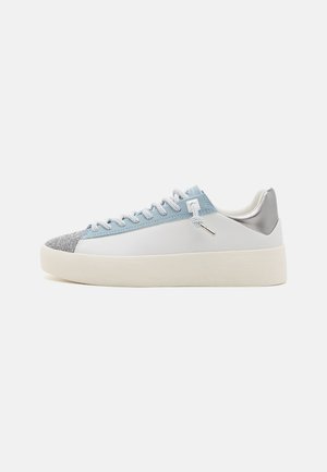 White sneakers with a light blue synthetic upper and textured silver accent on the heel, featuring a flat sole and patterned toe cap.