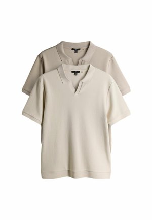 Two short-sleeve knit polo shirts, one beige in front and one light brown behind, displayed against white background.