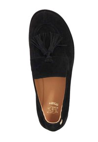 Black suede slip-on shoe with a rounded toe, adorned with two flat tassels. Features a tan leather insole and subtle stitching detail.