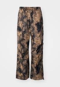 Bruna och svarta batikmönstrade vidbyxor med elastisk midja och justerbar dragsko, som har sidofickor och en mjuk textileffekt.