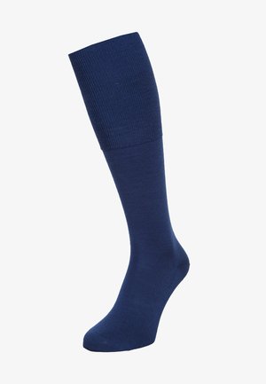 Calza al ginocchio blu navy realizzata in un materiale liscio e elastico, con dettaglio a coste nella parte superiore e area della punta rinforzata.