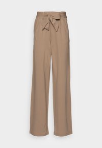 Pantaloni beige a gamba larga con vita alta e dettaglio nodo frontale, realizzati in tessuto morbido. Presentano delle pieghe e una texture liscia.