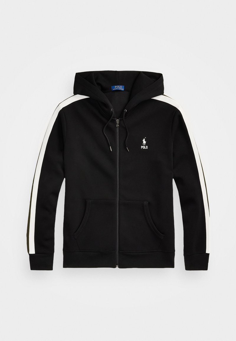 Svart zip-up hoodie i mjukt material, med vita sidostripes, en känguruficka och en broderad logotyp på vänster bröst.