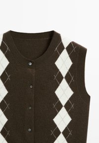 Brown sleeveless cardigan with white and brown argyle diamond patterns and four front buttons on a white background.