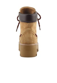 Bota de ante color marrón claro con un collar acolchado de cuero marrón, cordones redondos en burdeos y dorado, y una suela sintética gruesa color beige. Talla 37.