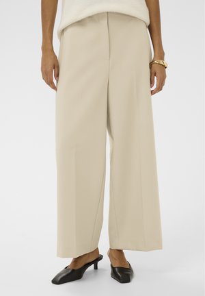 - Spodnie materiałowe