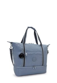 Modrá nylonová taška se proužkovanými šedými a černými uchy, zaobleného tvaru, se zipovým uzávěrem, přední kapsou a černým pom-pom klíčenkovým akcentem.