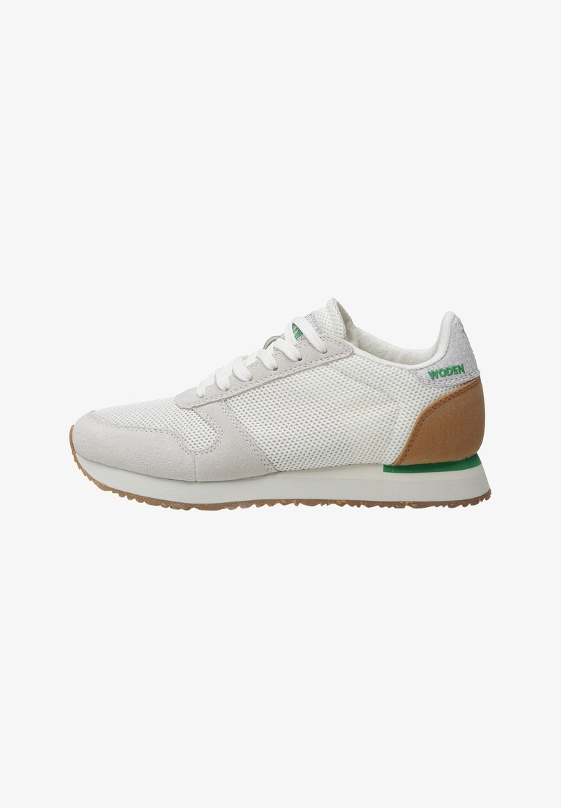 White athletic shoe with mesh upper, light gray suede accents, green branding, and a brown heel counter. Textured rubber sole provides grip.