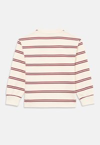 Long-sleeve cotton top featuring cream fabric with maroon horizontal stripes. Round neckline and gathered cuffs add subtle detail.
