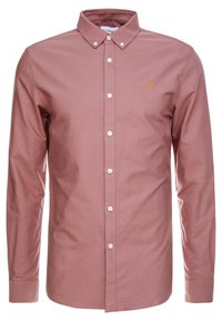 Knappup skjorta i dammrosafärg, tillverkad av bomull. Har krage, långa ärmar, vita knappar och en liten broderad logotyp på bröstet.