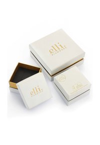 Boîtes à bijoux blanches avec marquage doré ; comprend une petite boîte intérieure noire et une boîte extérieure plus grande avec un symbole de recyclage.