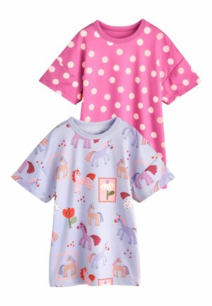 Two children’s short-sleeve shirts: one pink with white polka dots, one light purple with colorful unicorn and flower patterns.