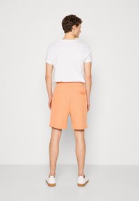 HUGO Treniņtērpa apakšdaļas - medium orange