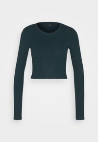 Dunkelgrünes, langärmeliges, geripptes Crop-Top mit rundem Ausschnitt. Glatte Textur und figurbetontes Design, ideal zum Schichten oder für die Freizeit.
