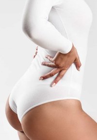 Witte lange mouwtop van rekbare stof, aansluitend ontwerp, accentueert de lichaamsvorm, hoge taille, gladde textuur, met een naadloze afwerking.