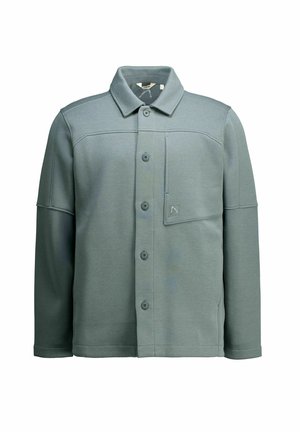 Hemdjacke in einer gedämpften grünen Farbe, aus weichem Stoff gefertigt. Verfügt über einen Kragen, Knöpfe vorne und eine Brusttasche. Glatte Textur.