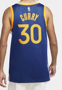 Modrý sportovní dres vyrobený z síťoviny, obsahuje žluté akcenty, na zadní straně zobrazuje "CURRY" a číslo "30", s logem NBA nad ním.