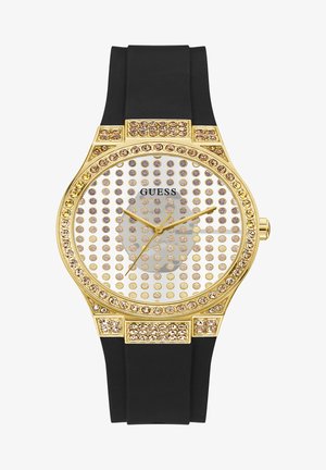 Orologio dorato con quadrante rotondo, è decorato con cristalli trasparenti, cinturino in gomma nera e lancette dorate su uno sfondo a pois.