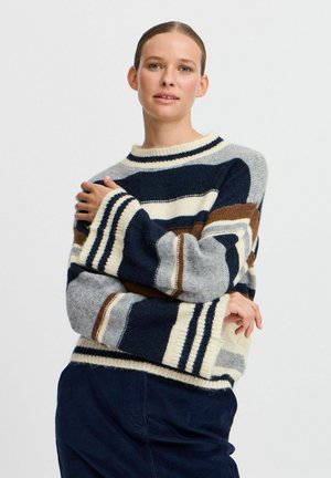 Maglione a righe con colori navy, beige, grigio e marrone. Trama a maglia grossa con scollatura a girocollo e maniche ampie.