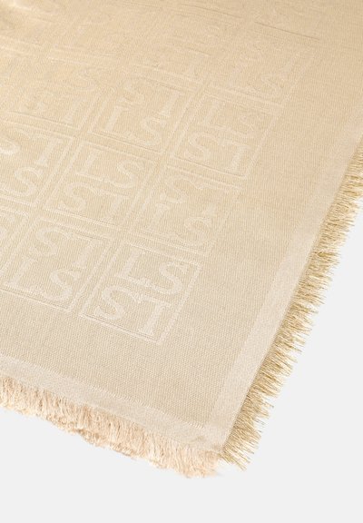 Beige woven rug featuring a raised square pattern and fringed edges. Soft texture, subtle sheen, and clean lines enhance its design.