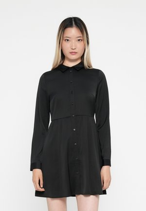 Zwarte jurk met kraag, lange mouwen, knoopsluiting en een uitlopende rok. Vlotte stof met een eenvoudig, elegant ontwerp.