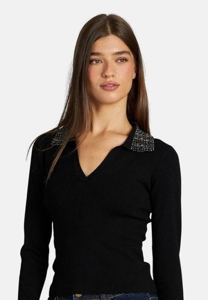 Maglione nero a maniche lunghe con scollatura a V e colletto decorato. Il colletto presenta un dettaglio testurizzato e scintillante. Design aderente.