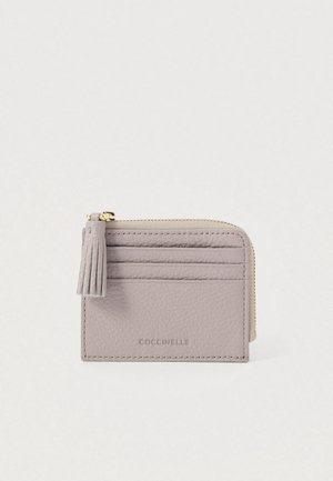 Light gray leather cardholder with three card slots, a zipper with tassel pull, and embossed brand name "COCCINELLE" on front.