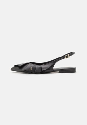 Black leather slingback shoe featuring a ruffled design on the toe and a gold bee accent, with a low, flat heel and adjustable strap.