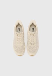 Light beige sneakers featuring a textured knit upper with small accents, flat laces, cushioned insole, and rubber outsole. Size 37.