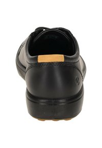 Scarpa in pelle nera con finitura liscia, caratterizzata da un accento marrone sul tallone e una suola in gomma resistente. Design casual con cuciture sottili.