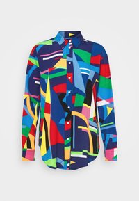 Koszula z guzikami w wielu kolorach z geometrycznym wzorem w odcieniach niebieskiego, czerwonego, zielonego i żółtego. Wykonana z gładkiego materiału, z kołnierzykiem i długimi rękawami.