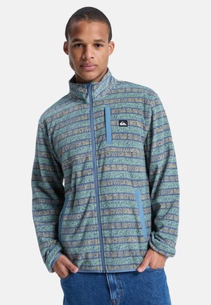 Fleece jacket in muted blue-green with a patterned design featuring horizontal stripes and a zippered chest pocket. Ribbed collar and cuffs.