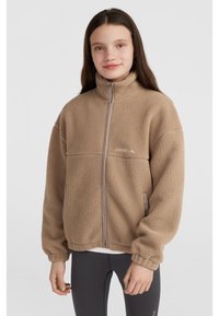 Tan, plush fleece jacket with a high collar, full zipper, and elastic cuffs. Features a logo on the chest and side pockets.