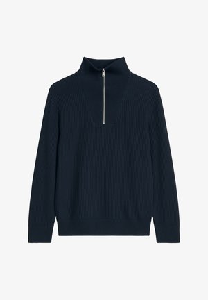 Pull en maille côtelée bleu marine avec manches longues et une courte fermeture éclaire argentée au col montant.