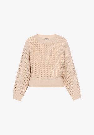 Austa dzija mīkstā bežā krāsā ar strukturētu, atvērtu audumu un ribotām piedurknēm un apmale. Iezīmē klasisku apaļu kaklu un īsu garumu.