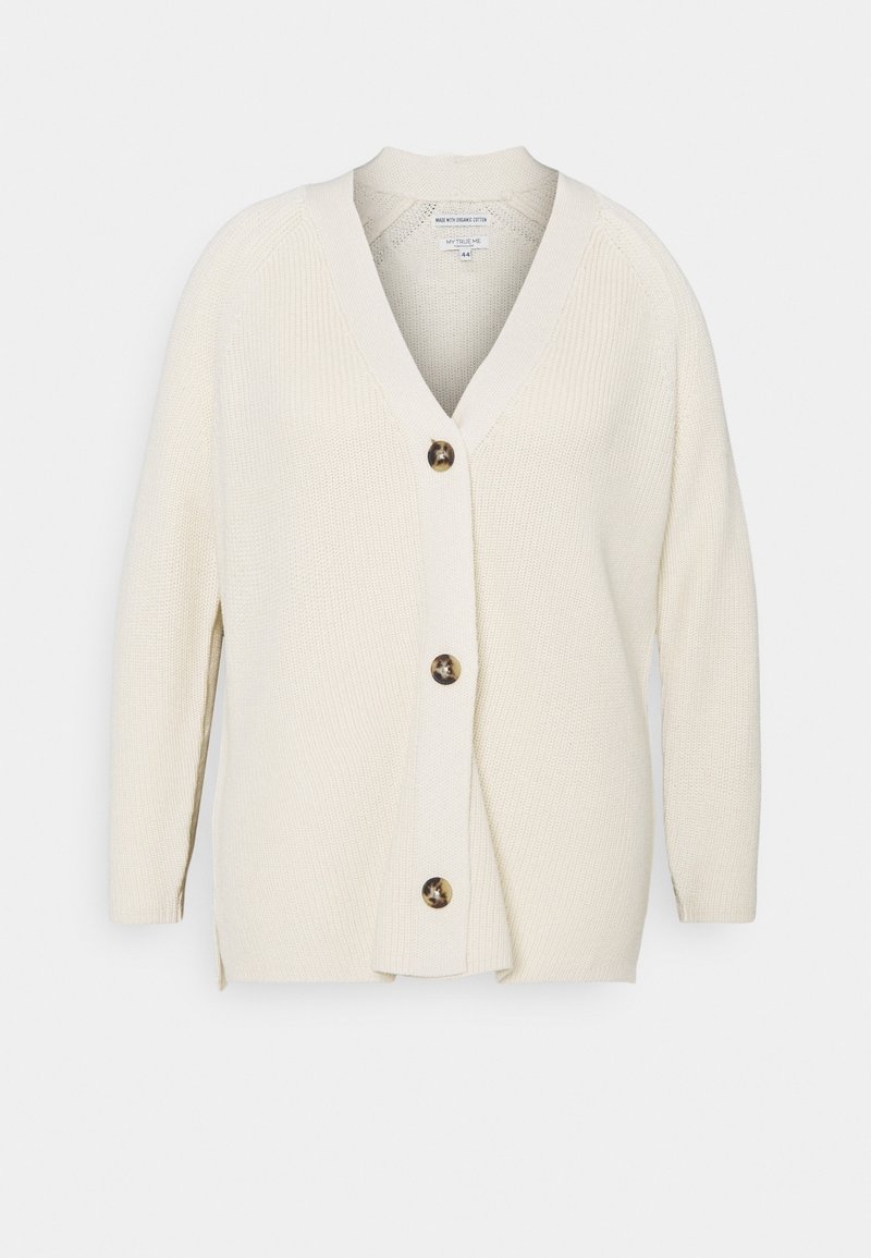 Cardigan color crema con scollo a V, texture a coste e grandi bottoni marroni sul davanti. Presenta maniche lunghe e una vestibilità comoda.