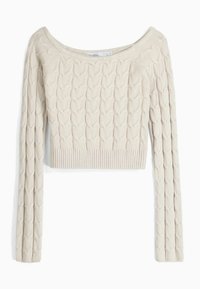 Cropped beige sweater with a textured heart pattern, ribbed hem, and long sleeves. Made from a soft knit material.