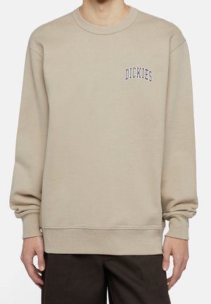 Beige Rundhals-Sweatshirt aus Baumwollmischung mit gerippten Bündchen und Saum. Auf der Vorderseite befindet sich das „DICKIES“-Logo in dunkelblauer Stickerei.