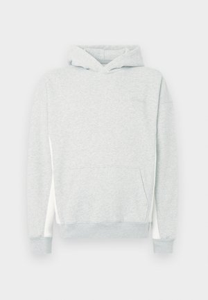 Light gray hoodie made of soft fabric, featuring a front pocket, drawstring hood, and contrasting white side panels. Ribbed cuffs and hem.