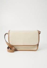 Sac en toile texturée beige à bandoulière avec une sangle et des finitions en cuir marron, doté d'une fermeture à rabat et de détails de couture visibles.