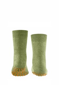 Chaussettes en coton vert avec bords côtelés, dotées de grips texturés orange sur les semelles pour une meilleure adhérence.