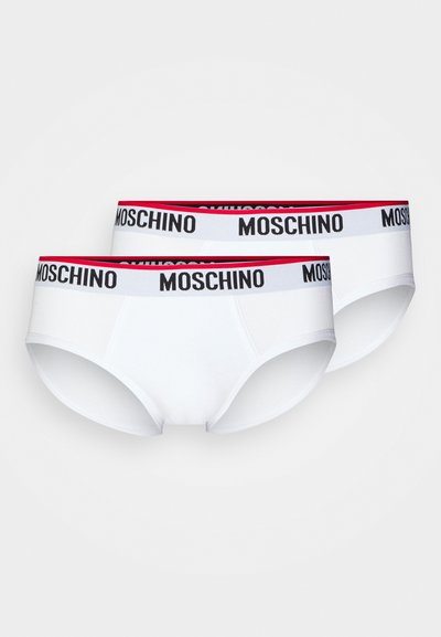 Baltas kokvilnas apakšveļa ar melnu un sarkanu Moschino logo jostu. Dizains ir klasiskā stila ar gludu tekstūru un drošu piegulšanu.