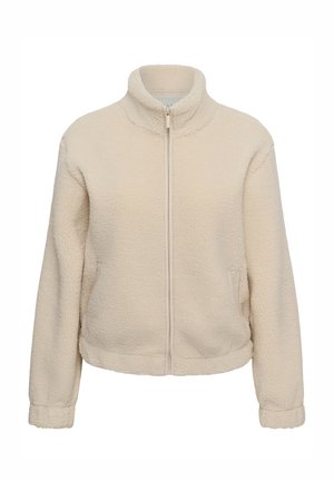 Veste en polaire beige à fermeture éclair, col montant, manches longues et poches latérales, mettant en valeur un tissu doux et texturé.
