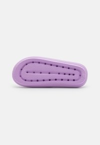 Purple rubber shoe sole with a textured surface, featuring ventilation holes and a rounded shape. Herringbone pattern along the edges.