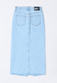 Falda midi de mezclilla azul claro con un costura central en la parte posterior, dos bolsillos traseros y una etiqueta en la cinturilla. Textura suave con un diseño de corte recto.
