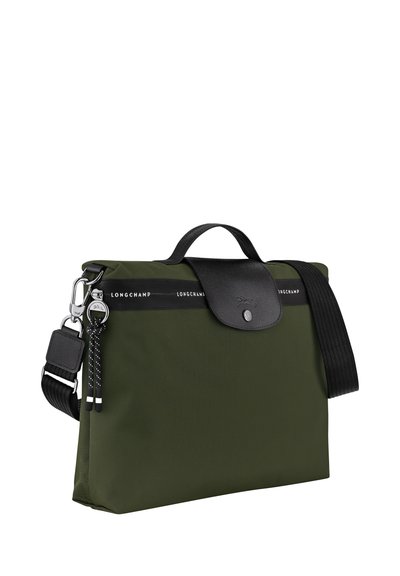 Green nylon shoulder bag with black leather accents, featuring a top handle, adjustable strap, and metal hardware. Longchamp branding visible.