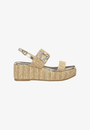 Sandale beige tissée avec une semelle plateforme, une sangle métallique et des accents décoratifs en strass sur la bande supérieure.