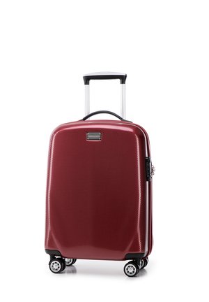Valigia rigida rossa con superficie texturizzata, quattro ruote e manico telescopico. Presenta una zip nera e una piastra con logo.