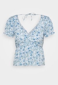 Blusa floreale con maniche a palloncino corte, scollatura a V e vita arricciata. Il motivo presenta fiori blu e verdi su uno sfondo chiaro.