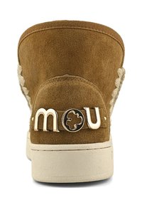 Stivale alla caviglia in suede marrone con suola in gomma crema, cuciture decorative e logo "mou" dorato sul tallone. Parte superiore testurizzata.